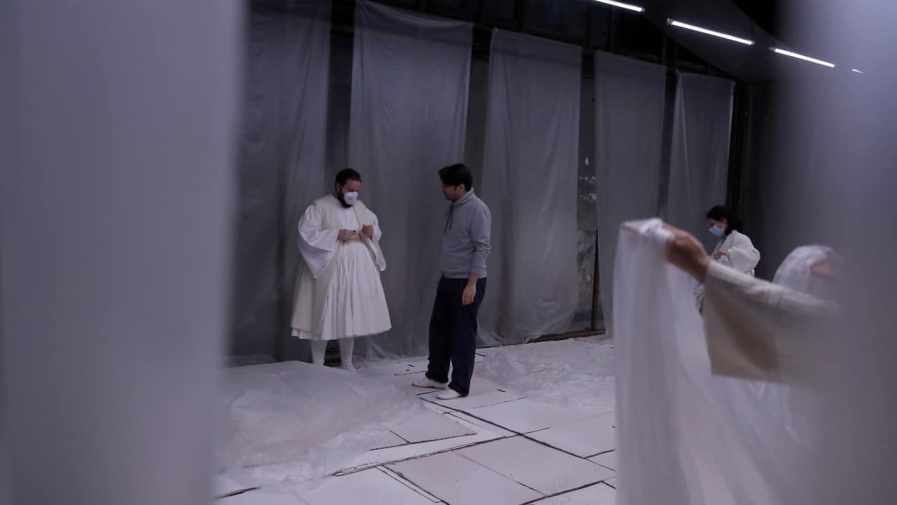 Actors Marios Panagiotou, left, and Konstantinos Arnokouros speak, during a rehearsal of &quot;The Free Besieged&quot; at the Greek National Theater in Athens on March 2, 2021. (AP Photo/Thanassis Stavrakis)