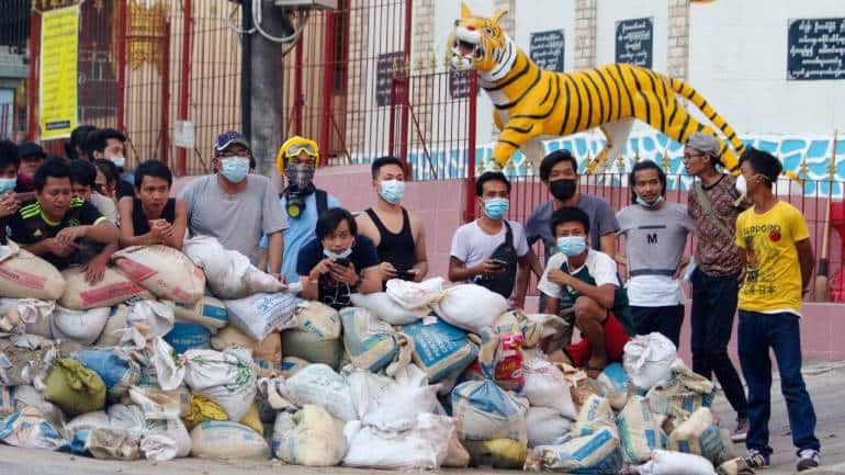 Protesters stand behind a barricade at Sanchaung district in Yangon, Myanmar, on March 8, 2021. (Image: Reuters/Stringer)
