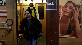 Subway riders wearing protective face masks exit the shuttle train during the coronavirus pandemic at the Times Square stop in New York City, US on March 11, 2021. (PC-REUTERS/Shannon Stapleton)