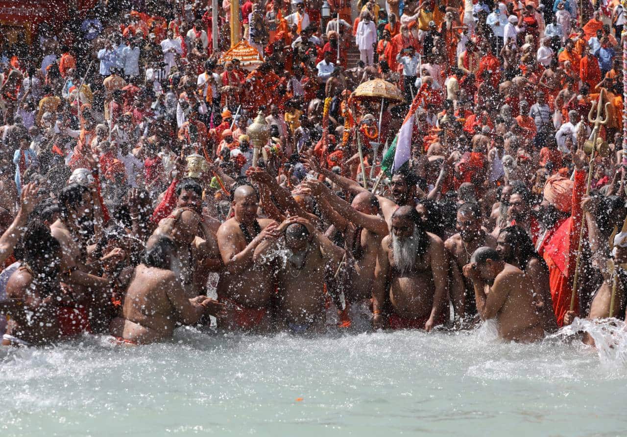 In Pics First Shahi Snan Of Kumbh Mela Thousands Of Devotees Take Dip In Holy Ganga 