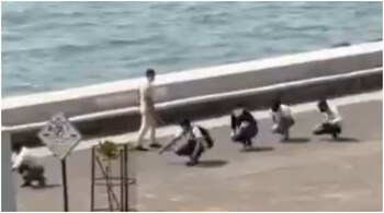 Face mask rule violators at Marine Drive in Mumbai being made to do a ‘Murga’ walk by cops. Source: Twitter.