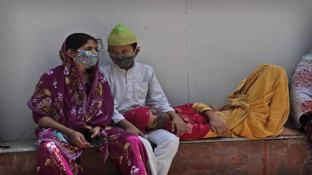 A family waits to receive the body of a person who died due to COVID-19 outside a mortuary, in New Delhi, India, Monday, April 19, 2021. (Image: AP) A family waits to receive the body of a person who died due to COVID-19 outside a mortuary, in New Delhi, India, Monday, April 19, 2021. (Image: AP)