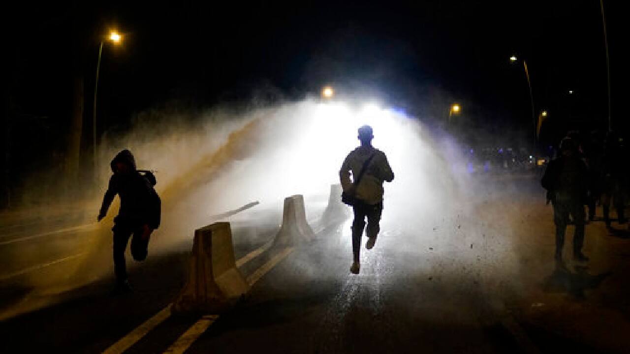 Police use a water cannon during clashes at the Bois de la Cambre park in Brussels, April 1. Belgian police confronted a large crowd in one of the city's largest parks as thousands of revelers had gathered for an unauthorized event despite coronavirus restrictions. (Image: AP)