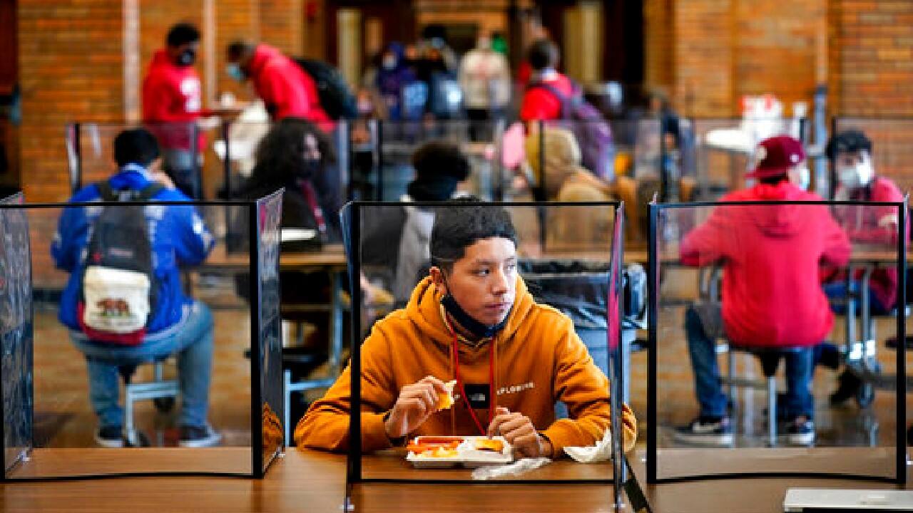 Freshman Hugo Bautista eats lunch separated from classmates by plastic dividers at Wyandotte County High School in Kansas City, Kan., on the first day of in-person learning, March 31. The district was one of the last in the state to return to the classroom after going virtual due to the COVID-19 pandemic. (Image: AP)
