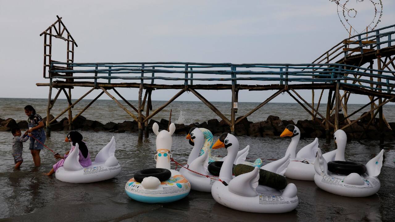Villagers play at Rembat beach, one of several tourist places which is threatened by abrasion in Indramayu regency, West Java province, Indonesia. (Image: Reuters)