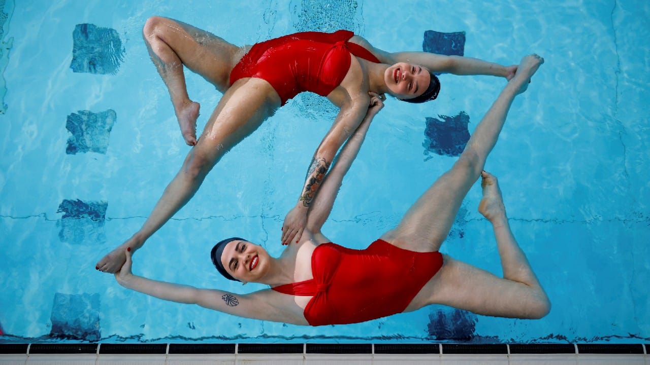 Synchronised swimmers from Aquabatix train in the pool as swimming pools reopen following easing of the coronavirus restrictions, at Clissold Leisure Centre, in London, Britain April 12. (Image: Reuters)