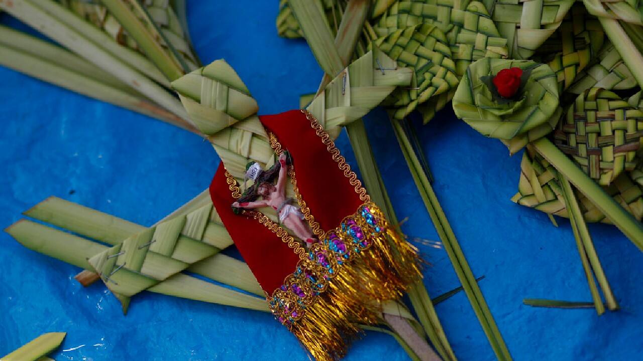 In Bolivia, crosses woven from lush palm fronds were arrayed on a blue tarp for sale outside the San Francisco Basilica. (Image: AP) In Bolivia, crosses woven from lush palm fronds were arrayed on a blue tarp for sale outside the San Francisco Basilica. (Image: AP)