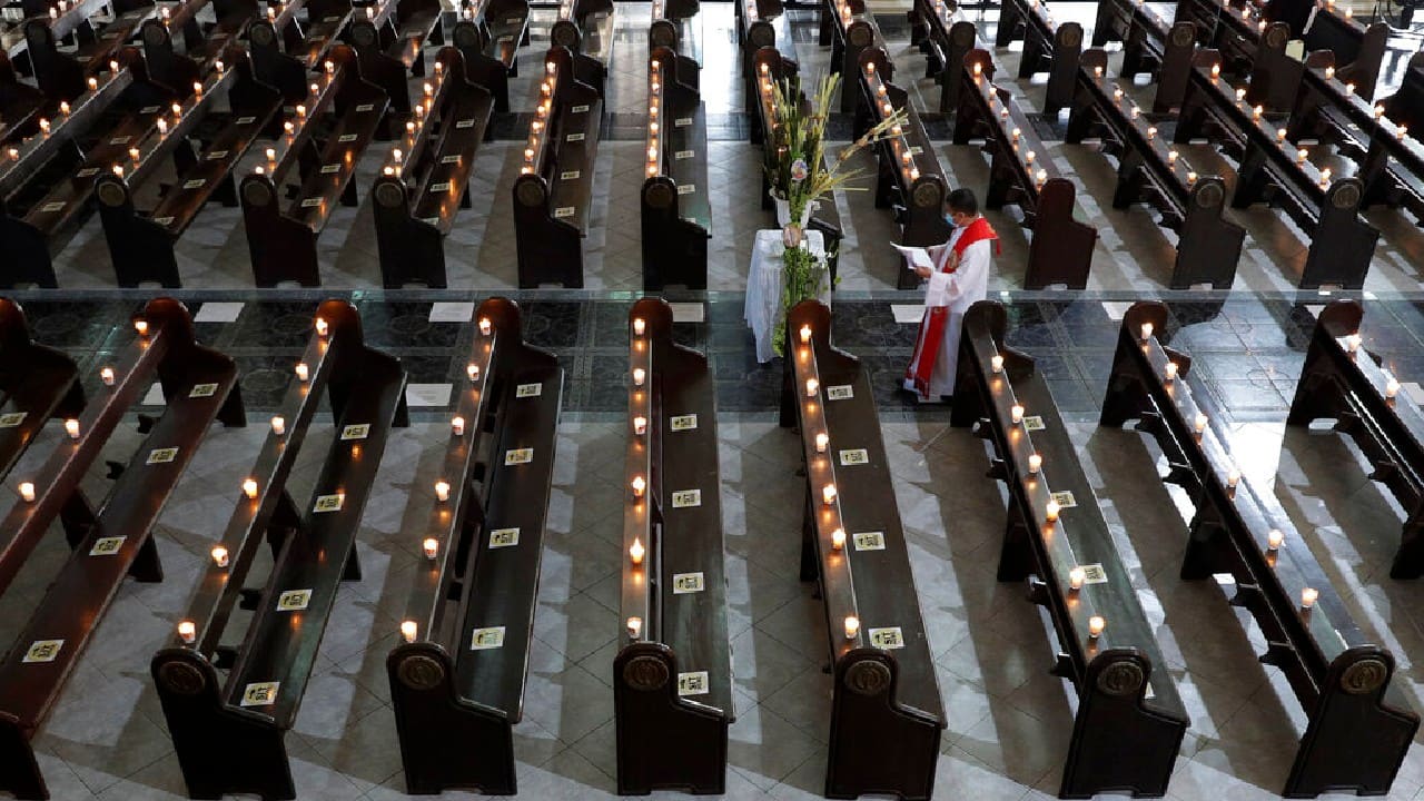 That was a stark contrast with the scene at Saint Peter Parish Church in the Philippines, where a priest walked past empty pews with lit candles in preparation for an online Mass after the government banned religious activities during Holy Week and toughened lockdown measures to try to contain an alarming surge of the coronavirus. (Image: AP) That was a stark contrast with the scene at Saint Peter Parish Church in the Philippines, where a priest walked past empty pews with lit candles in preparation for an online Mass after the government banned religious activities during Holy Week and toughened lockdown measures to try to contain an alarming surge of the coronavirus. (Image: AP)