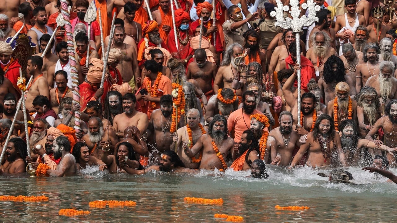 Hindu holy men take holy a dip in River Ganga during the Kumbh Mela in Haridwar, Uttarakhand on April 12, 2021. (Image: AP Photo/Karma Sonam)