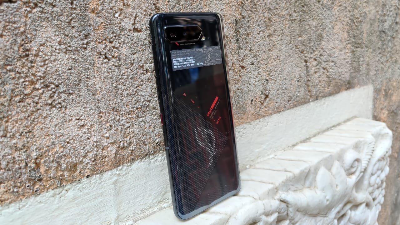 Asus ROG Phone 5 | Rs 49,999 | If you don’t mind the gaming aesthetic and the hefty build, the Asus ROG Phone 5 is just as much a flagship as any other smartphone on this list, if not better. The ROG Phone 5 features a Snapdragon 888 chipset, a 144Hz AMOLED display, a massive 6,000 mAh battery with 65W fast-charging support, a 64 MP triple-camera setup, and excellent software. Despite being targeted towards gamers, the ROG Phone 5 has a solid camera setup and a vibrant display. Asus ROG Phone 5 | Rs 49,999 | If you don’t mind the gaming aesthetic and the hefty build, the Asus ROG Phone 5 is just as much a flagship as any other smartphone on this list, if not better. The ROG Phone 5 features a Snapdragon 888 chipset, a 144Hz AMOLED display, a massive 6,000 mAh battery with 65W fast-charging support, a 64 MP triple-camera setup, and excellent software. Despite being targeted towards gamers, the ROG Phone 5 has a solid camera setup and a vibrant display.