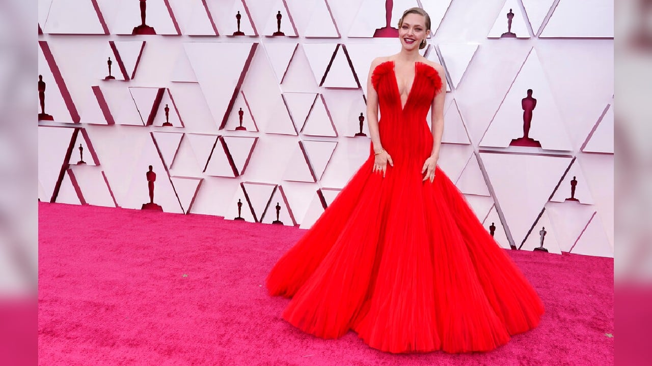 Amanda Seyfried chose vibrant red from Armani Prive, her hair in an Old Hollywood side-swept updo. It was among a slew of classic princess cuts, hers a strapless look with a plunging neckline. (Image: AP)