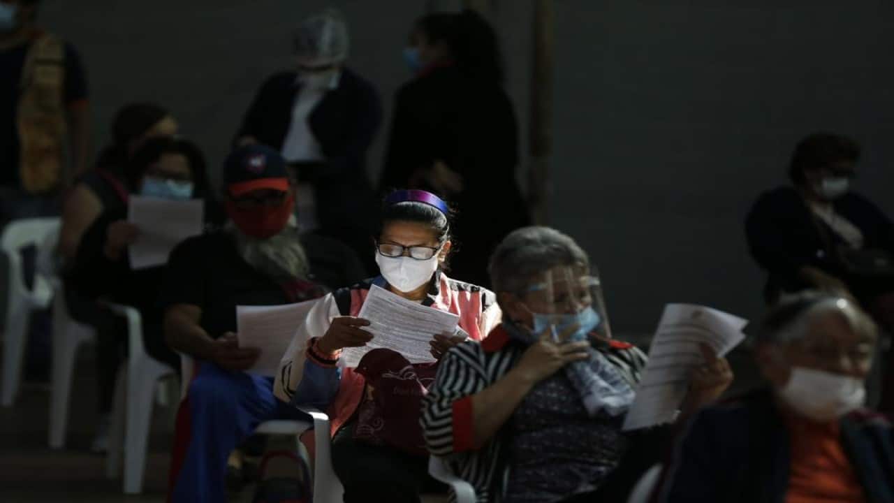 People over age 65 read instructions before getting a shot of the AstraZeneca COVID-19 vaccine in San Lorenzo, Paraguay, Tuesday, May 18, 2021. (Image: AP)