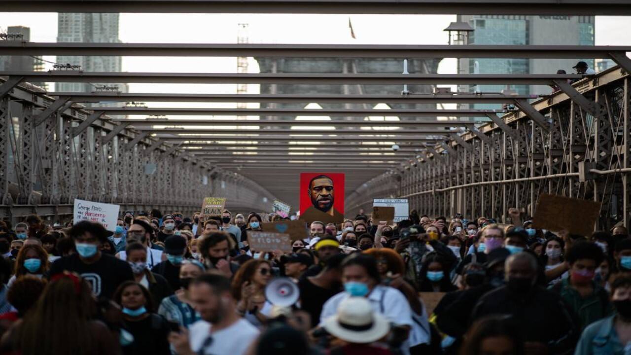 Demonstrators march across the Brooklyn Bridge as they remember George Floyd on the one-year anniversary of his death, Tuesday, May 25, 2021, in New York. (AP Photo/Eduardo Munoz Alvarez)