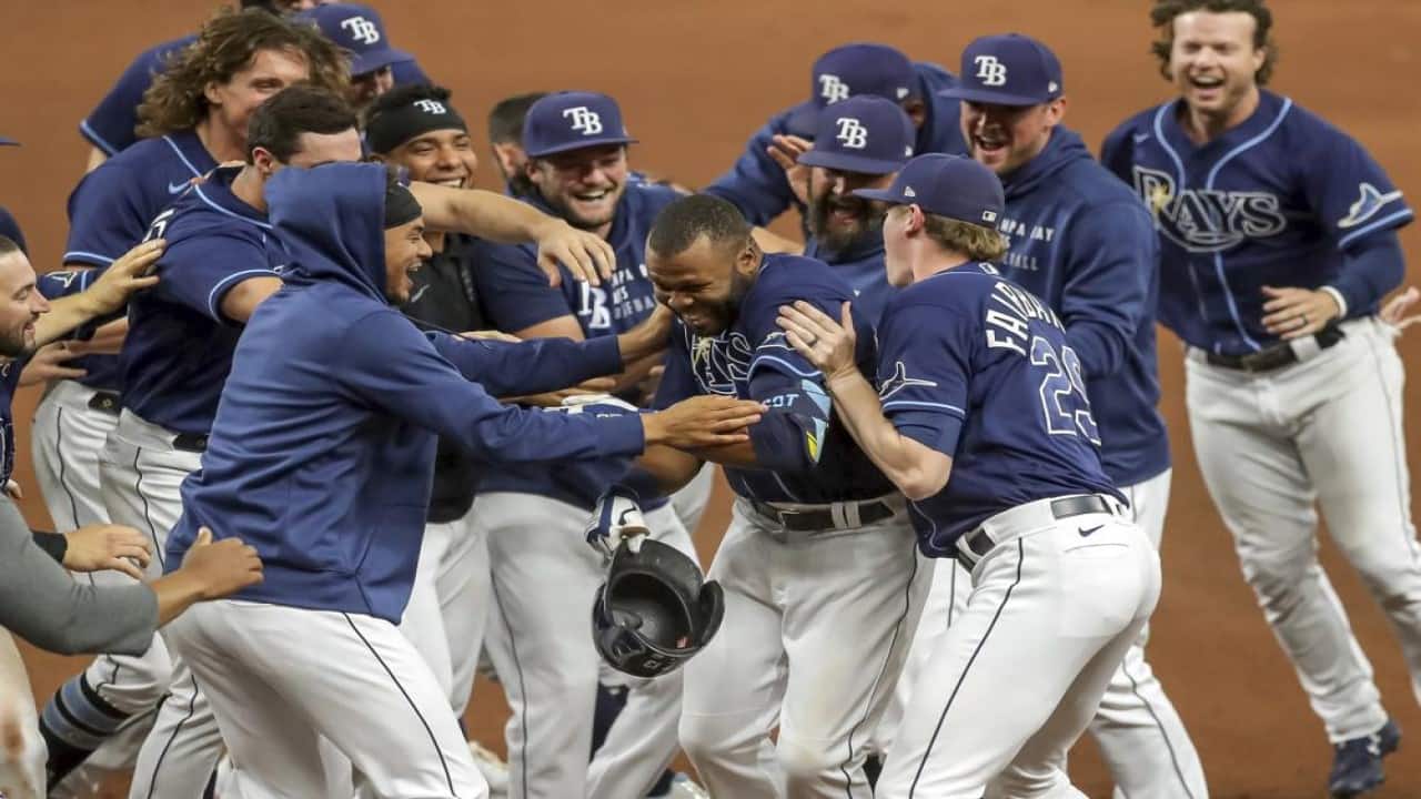 Tampa Bay Rays' Manuel Margot, center, is congratulated by teammates after his game-winning single against the Kansas City Royals during the 10th inning of a baseball game Wednesday, May 26, 2021, in St. Petersburg, Fla. The Rays won 2-1. (AP Photo/Mike Carlson)
