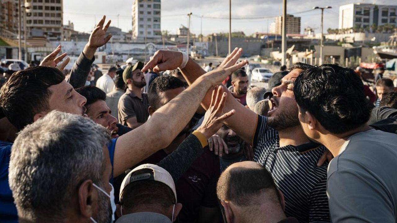 An auctioneer takes bids for a lot of fish as the day's catch is sold to buyers after a limited number of fishing boats were allowed to return to the sea following a cease-fire reached after an 11-day war between Hamas and Israel, in Gaza City, Sunday, May 23, 2021. (AP Photo/John Minchillo) An auctioneer takes bids for a lot of fish as the day's catch is sold to buyers after a limited number of fishing boats were allowed to return to the sea following a cease-fire reached after an 11-day war between Hamas and Israel, in Gaza City, Sunday, May 23, 2021. (AP Photo/John Minchillo)