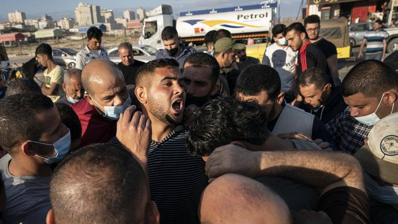 An auctioneer shouts numbers to recorders as the day's catch is sold to buyers after a limited number of fishing boats were allowed to return to the sea following a cease-fire reached after an 11-day war between Hamas and Israel, in Gaza City, Sunday, May 23, 2021. (AP Photo/John Minchillo) An auctioneer shouts numbers to recorders as the day's catch is sold to buyers after a limited number of fishing boats were allowed to return to the sea following a cease-fire reached after an 11-day war between Hamas and Israel, in Gaza City, Sunday, May 23, 2021. (AP Photo/John Minchillo)