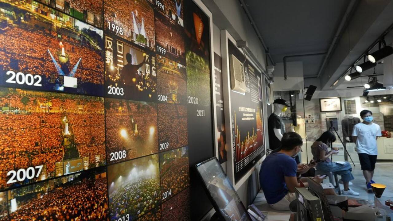 Pictures for past years of people gathered during a candlelight vigil at Victoria Park are displayed at the &quot;June 4 Memorial Museum&quot; run by pro-democracy activists in Hong Kong on Sunday, May 30, 2021. The museum commemorating the June 4, 1989, crackdown in Beijing reopened Sunday, in advance of this year's anniversary. The museum's organizer usually hosts an annual candlelight vigil, but in the face of a second year of refusal of permission from authorities on COVID-19 concerns, and the imprisonment of others for last year's event, this time, organizers said they would not try again, but keep their museum open til 10 p.m. on June 4. (AP Photo/Vincent Yu)