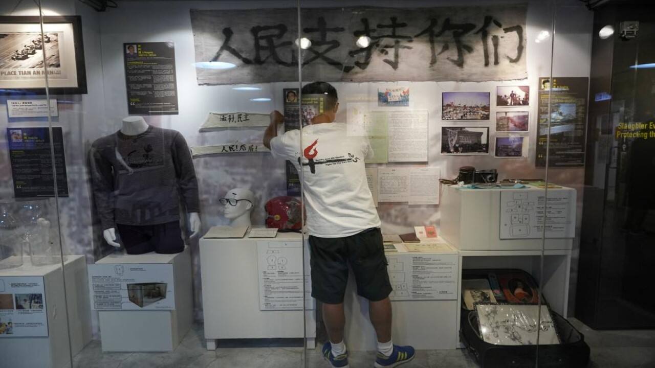 A staff member adjusts exhibits at the &quot;June 4 Memorial Museum&quot; run by pro-democracy activists in Hong Kong on Sunday, May 30, 2021. 