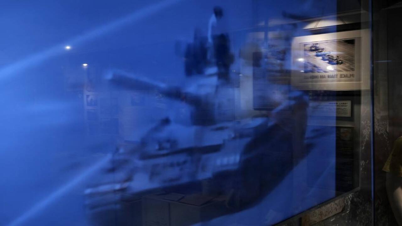 An image on a TV screen and a picture on the wall both showing a man blocking a line of tanks at the &quot;June 4 Memorial Museum&quot; run by pro-democracy activists in Hong Kong on Sunday, May 30, 2021. 