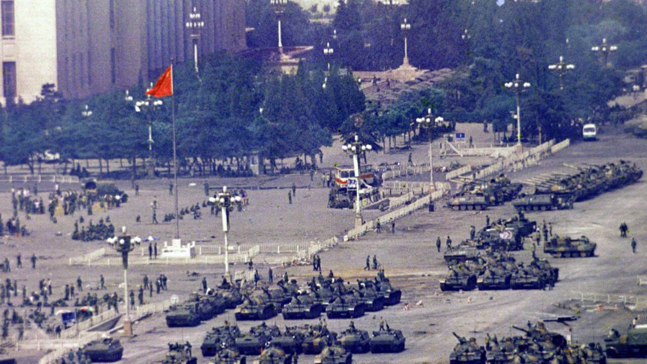 In this June 5, 1989, file photo, Chinese troops and tanks gather in Beijing, one day after the military crackdown that ended a seven week pro-democracy demonstration on Tiananmen Square. Hundreds were killed in the early morning hours of June 4. (AP Photo/Jeff Widener, File)