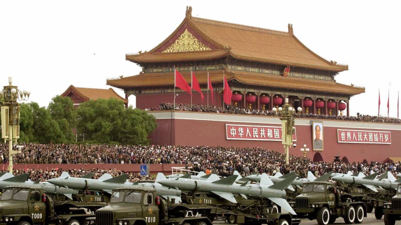 In this Oct. 1, 1999, file photo, a convoy of Chinese-made rocket launcher trucks moves through Tiananmen Square in Beijing. The Communist Party's $36 million celebration Friday will showcase the nation's growing military might and its rapid economic progress since Mao Zedong stood atop the Gate of Heavenly Peace on Oct. 1, 1949, and declared the founding of the People's Republic. (AP Photo/Vincent Yu, File)