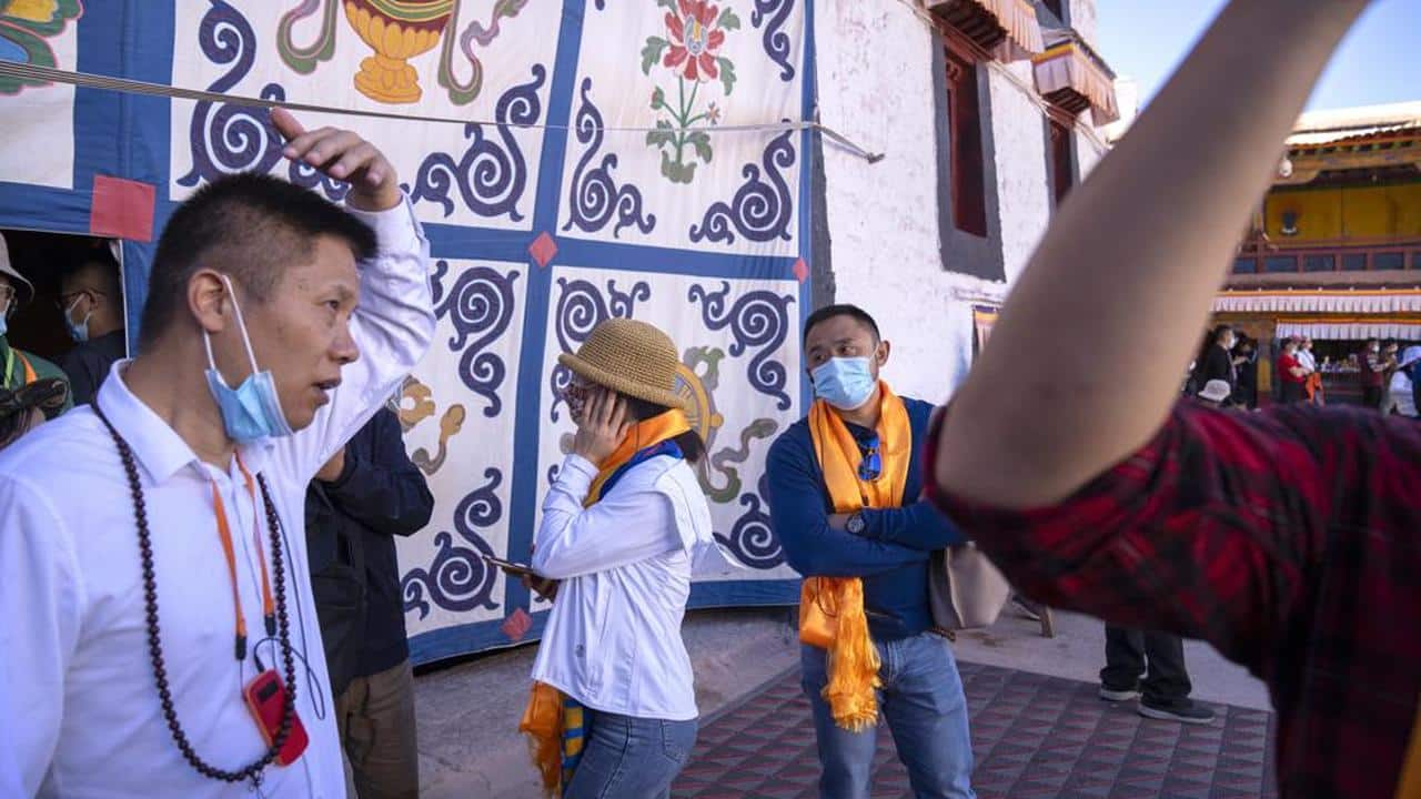Tourists use earpieces to listen to a lecture at the Potala Palace in Lhasa in western China's Tibet Autonomous Region, Tuesday, June 1, 2021. Tourism is booming in Tibet as more Chinese travel in-country because of the coronavirus pandemic, posing risks to the region's fragile environment and historic sites. (AP Photo/Mark Schiefelbein) Tourists use earpieces to listen to a lecture at the Potala Palace in Lhasa in western China's Tibet Autonomous Region, Tuesday, June 1, 2021. Tourism is booming in Tibet as more Chinese travel in-country because of the coronavirus pandemic, posing risks to the region's fragile environment and historic sites. (AP Photo/Mark Schiefelbein)