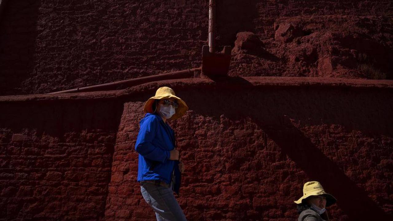 Tourists walk down a flight of steps at the Potala Palace in Lhasa in western China's Tibet Autonomous Region, Tuesday, June 1, 2021. Tourism is booming in Tibet as more Chinese travel in-country because of the coronavirus pandemic, posing risks to the region's fragile environment and historic sites. (AP Photo/Mark Schiefelbein) Tourists walk down a flight of steps at the Potala Palace in Lhasa in western China's Tibet Autonomous Region, Tuesday, June 1, 2021. Tourism is booming in Tibet as more Chinese travel in-country because of the coronavirus pandemic, posing risks to the region's fragile environment and historic sites. (AP Photo/Mark Schiefelbein)