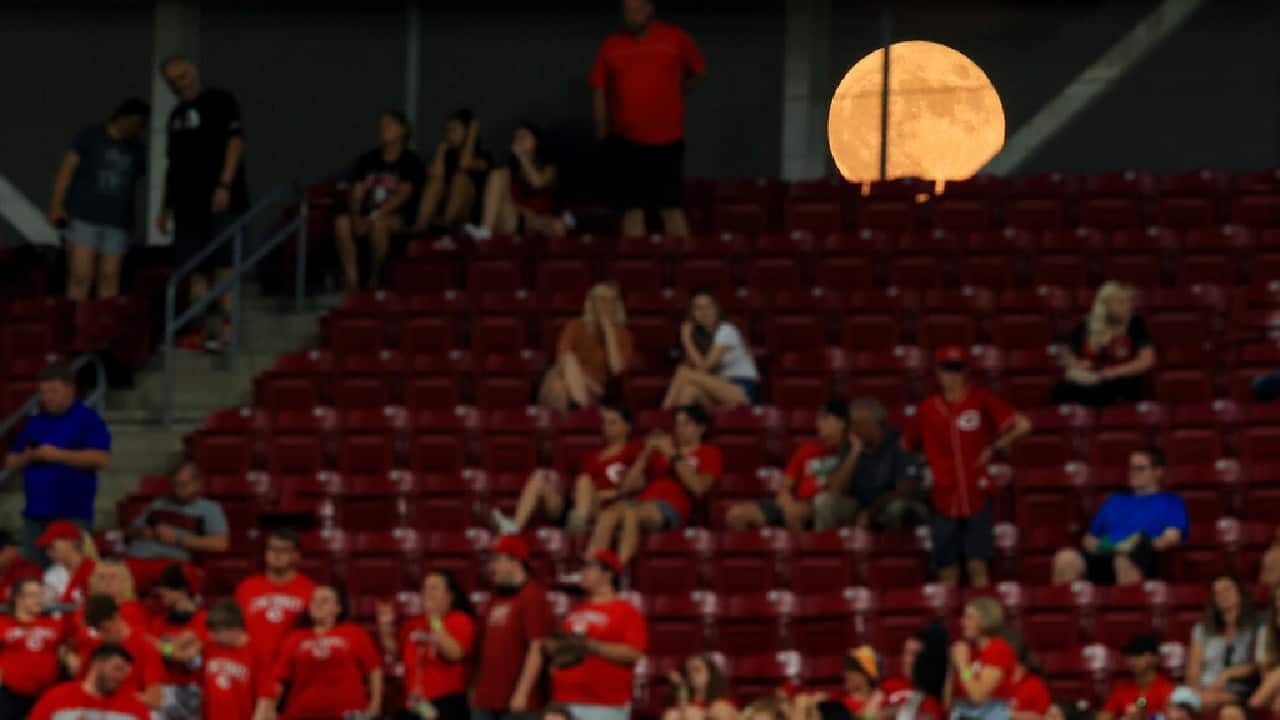 A view of the moon is seen through the outfield scoreboard during the ninth inning of a baseball between the Atlanta Braves and the Cincinnati Reds, June 24. The Reds won 5-3. (Image: AP)
