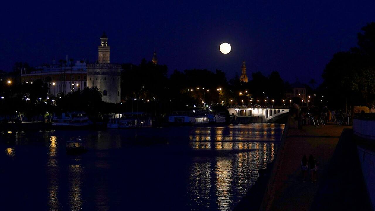 A view of the moon is seen through the outfield scoreboard during the ninth inning of a baseball between the Atlanta Braves and the Cincinnati Reds, June 24. The Reds won 5-3. (Image: AP)