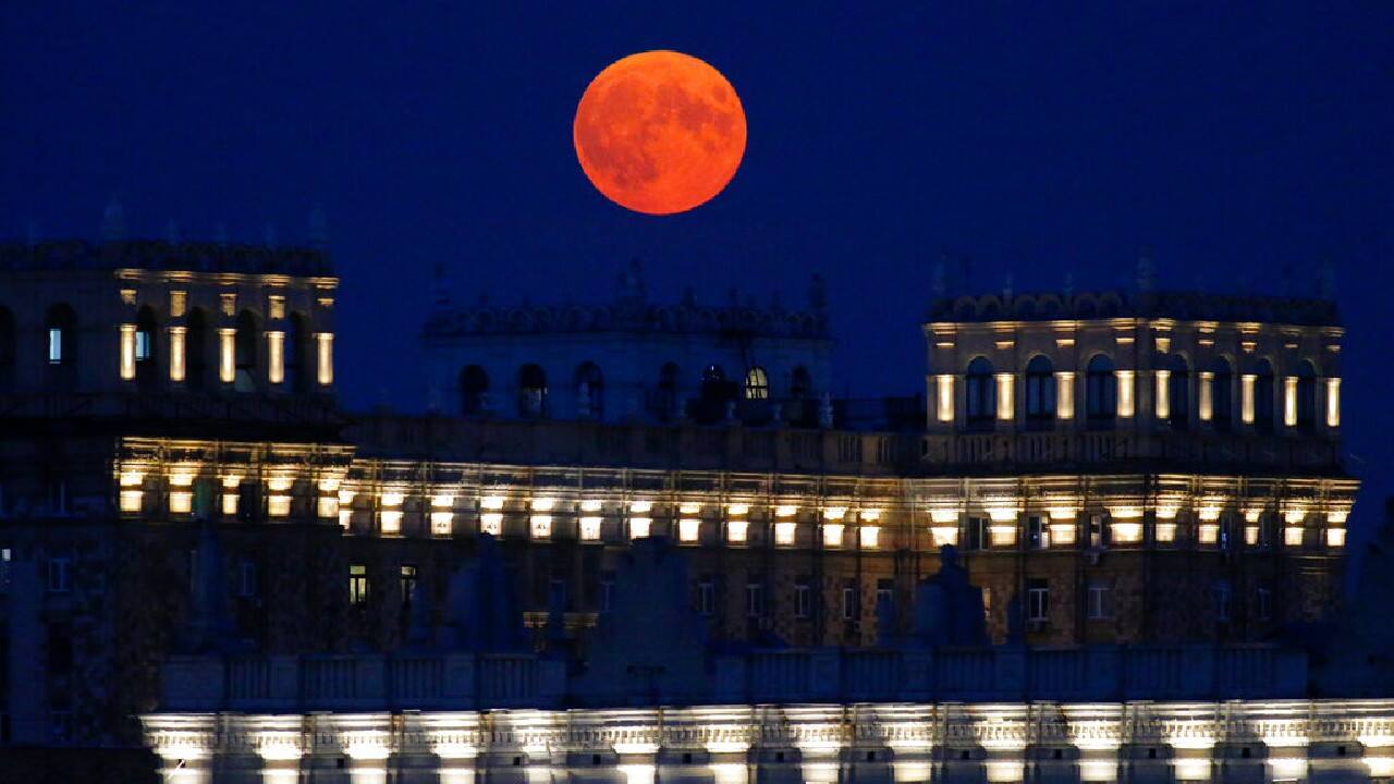 Full moon rises over illuminated buildings in Moscow, Russia on June, 24. (Image: AP)