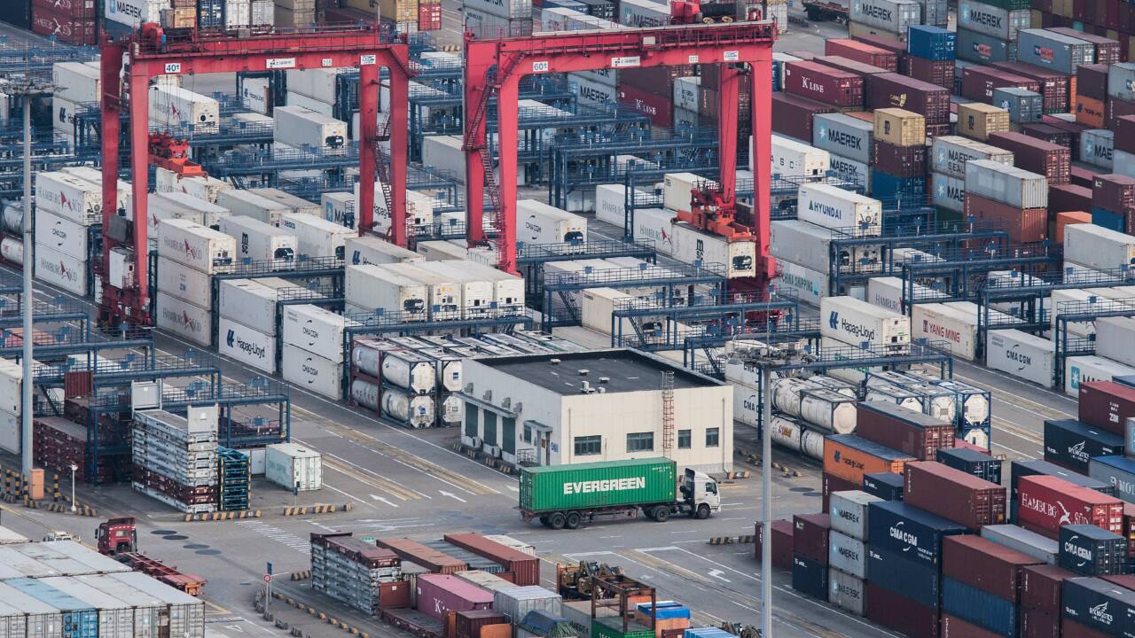 In this March 29, 2018, file photo, a cargo truck drives amid stacked shipping containers at the Yangshan port in Shanghai. Since seizing power amid civil war in 1949, the party has undergone a tumultuous history, but president and party leader Xi Jinping is emphasizing the country’s rise to economic, military and diplomatic over the past four decades since reforms were enacted. (AP Photo/File)