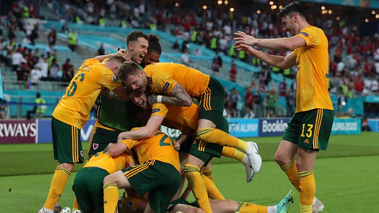 Welsh players celebrate after Connor Roberts scores his side's second goal (Tolga Bozoglu/Pool Photo via AP)