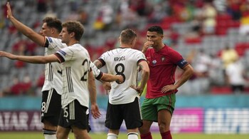 Portugal's Cristiano Ronaldo, right, talks to Germany's Toni Kroos after the Euro 2020 soccer championship group F match between Portugal and Germany in Munich, Saturday, June 19, 2021. (AP Photo/Matthias Schrader, Pool)