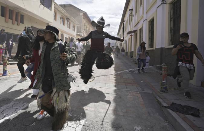 Revelers dance during the &quot;Inti Raymi,&quot; or Sun Festival celebrations, despite restrictions to prevent the spread of the coronavirus, in Cotacachi, Ecuador, Thursday, June 24, 2021. Across the Andes, from the tip of Argentina as far north as Colombia, indigenous communities gather in June for the southern hemisphere's winter solstice to pay homage to Inti, the ancient Incan sun god, in hopes of being granted a plentiful harvest. (AP Photo/Dolores Ochoa)