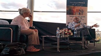 2014 photo of Prof. Daniel Kahneman (right) and Prof. Maya Bar Hillel talking about Kahneman's research. (Image via Wikimedia Commons CC 3.0).