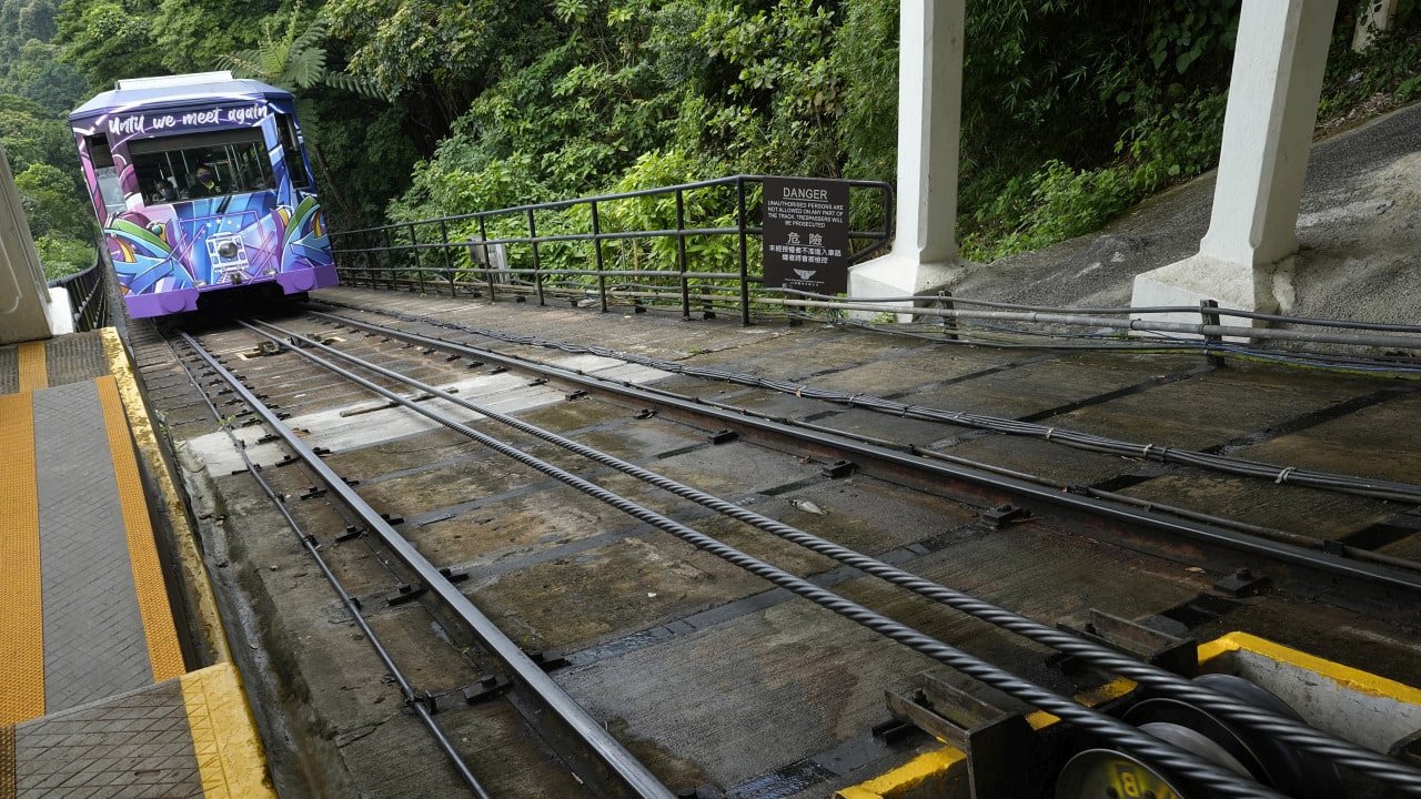 Cedric Yu, who said he hadn’t ridden the tram for years, called it a collective memory for Hong Kong people and part of the city's history. "Taking the Peak Tram just now reminds me of my childhood memories,” he added. (AP Photo/Vincent Yu)