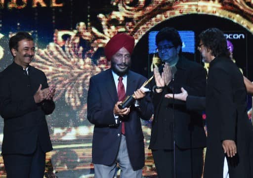 Bollywood director Rakeysh Omprakash Mehra (C-R) hands over the Best Picture trophy to Milkha Singh during the fourth and final day of the 15th International Indian Film Academy (IIFA) Awards at the Raymond James Stadium in Tampa, Florida, April 27, 2014. AFP PHOTO/Jewel Samad (Photo by JEWEL SAMAD / AFP) Bollywood director Rakeysh Omprakash Mehra (C-R) hands over the Best Picture trophy to Milkha Singh during the fourth and final day of the 15th International Indian Film Academy (IIFA) Awards at the Raymond James Stadium in Tampa, Florida, April 27, 2014. AFP PHOTO/Jewel Samad (Photo by JEWEL SAMAD / AFP)
