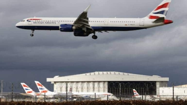British Airways owner IAG airline narrows loss in first half