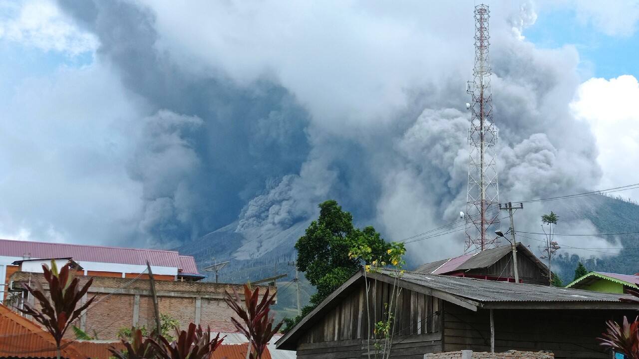 Mount Sinabung releases volcanic materials during an eruption as seen from a school yard in Karo, North Sumatra, Indonesia, July 28. The rumbling volcano on Indonesia's Sumatra Island shot billowing columns of ash and hot clouds down its slopes. (Image: AP)