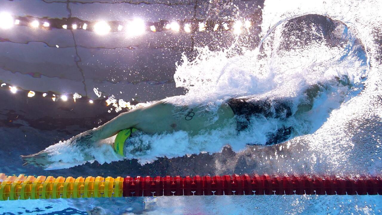 Australia's Kyle Chalmers dives in at the start of a 100-meter freestyle heat at the 2020 Summer Olympics, July 27, in Tokyo. (Image: AP)