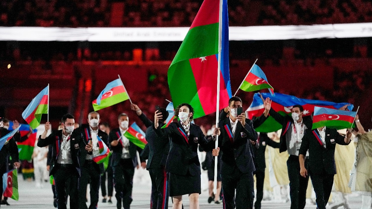Farida Azizova and Rustam Orujov, of Azerbaijan, carry their country's flag during the opening ceremony in the Olympic Stadium at the 2020 Summer Olympics, Friday, July 23, 2021, in Tokyo, Japan.
