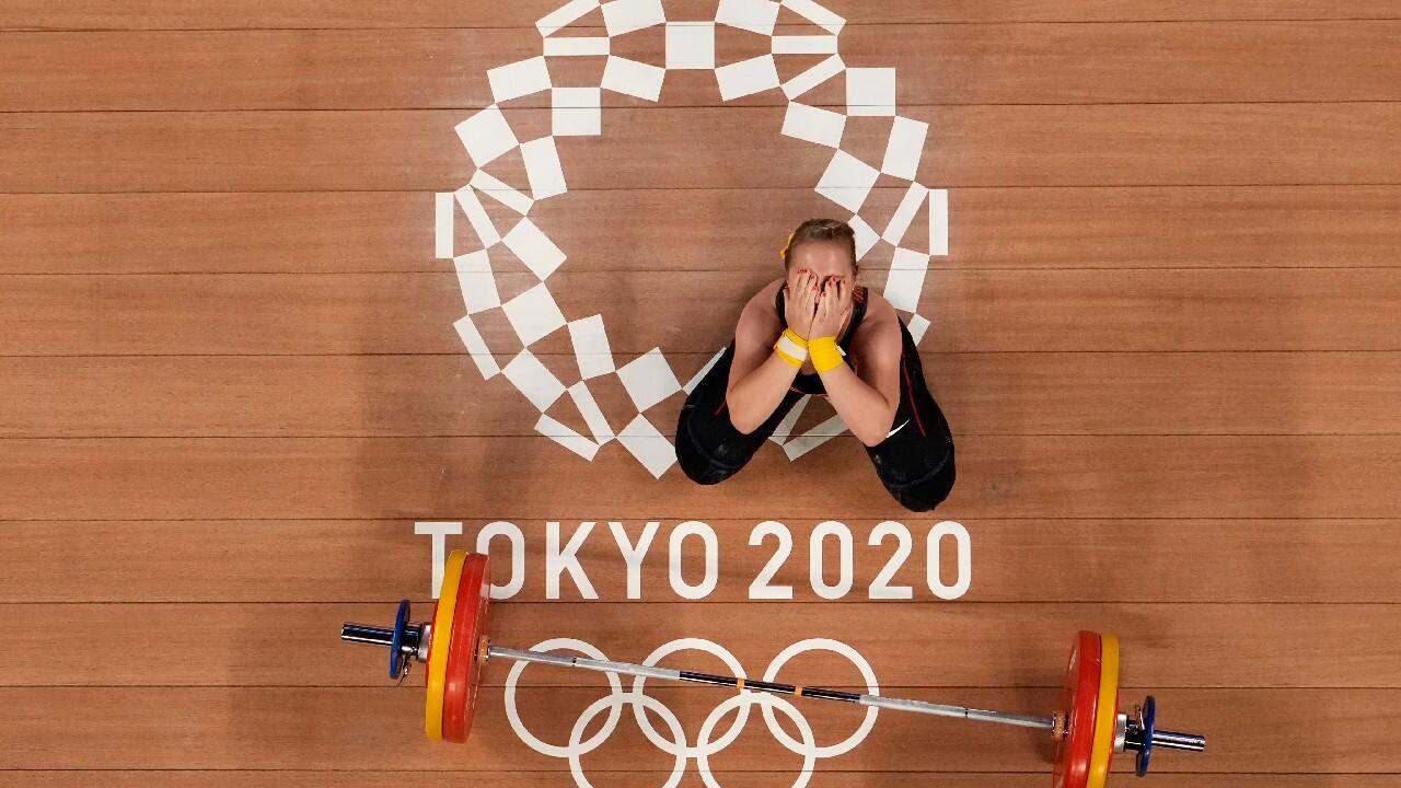 Sabine Beate Kusterer of Germany gestures after an unsuccessful lift during the women's 59kg weightlifting event, at the 2020 Summer Olympics, July 27, in Tokyo, Japan. (Image: AP)