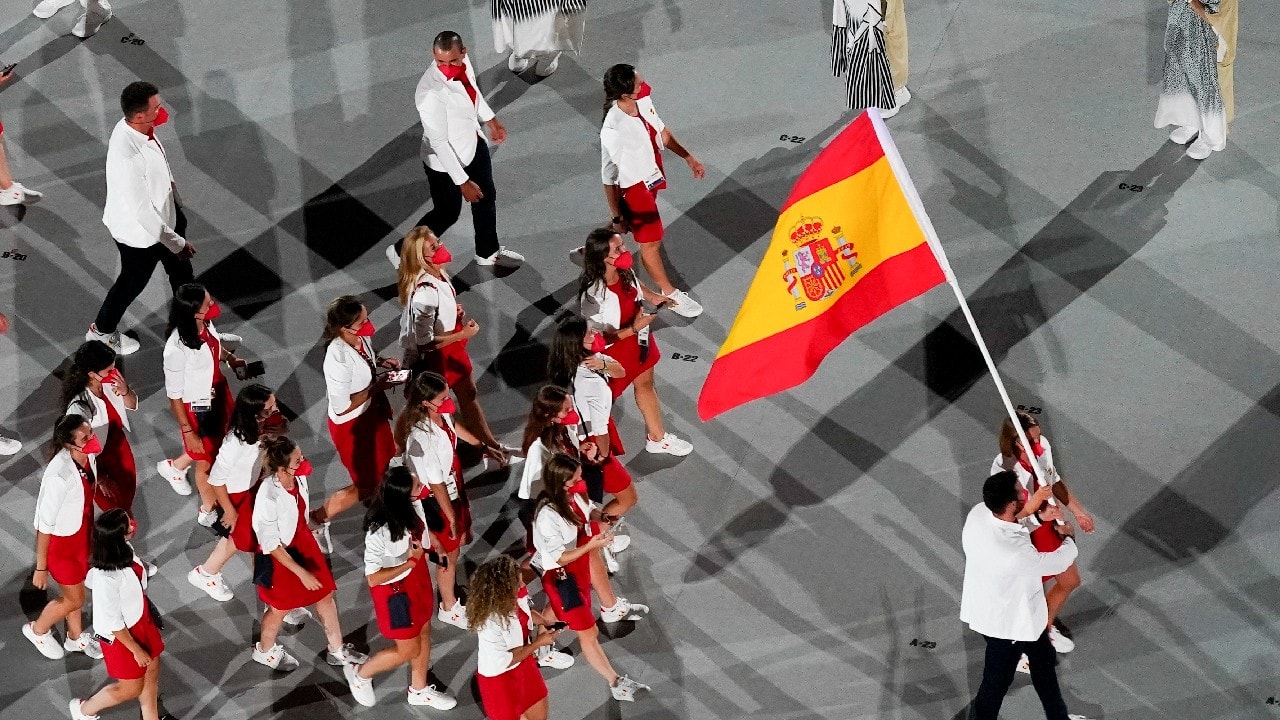 Mireia Belmonte and Saul Craviotto, of Spain, carry their country's flag during the opening ceremony at the Olympic Stadium at the 2020 Summer Olympics in Tokyo. (Image: AP)