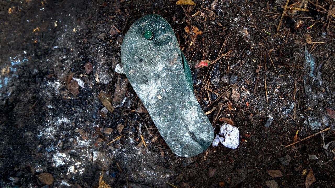 The personal belongings of cremated COVID-19 victims lie strewn around the grounds of the Ulubari cremation ground in Gauhati, the biggest city in India’s remote northeast. (Image: AP) The personal belongings of cremated COVID-19 victims lie strewn around the grounds of the Ulubari cremation ground in Gauhati, the biggest city in India’s remote northeast. (Image: AP)