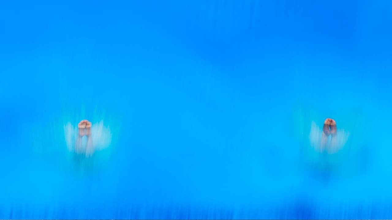 Like an overhead shot of Chinese divers Wang Zongyuan and Xie Siyi entering the water. Only their feet remain above the surface, equal in height at the end of a near-perfectly synchronized performance. (Image: AP)