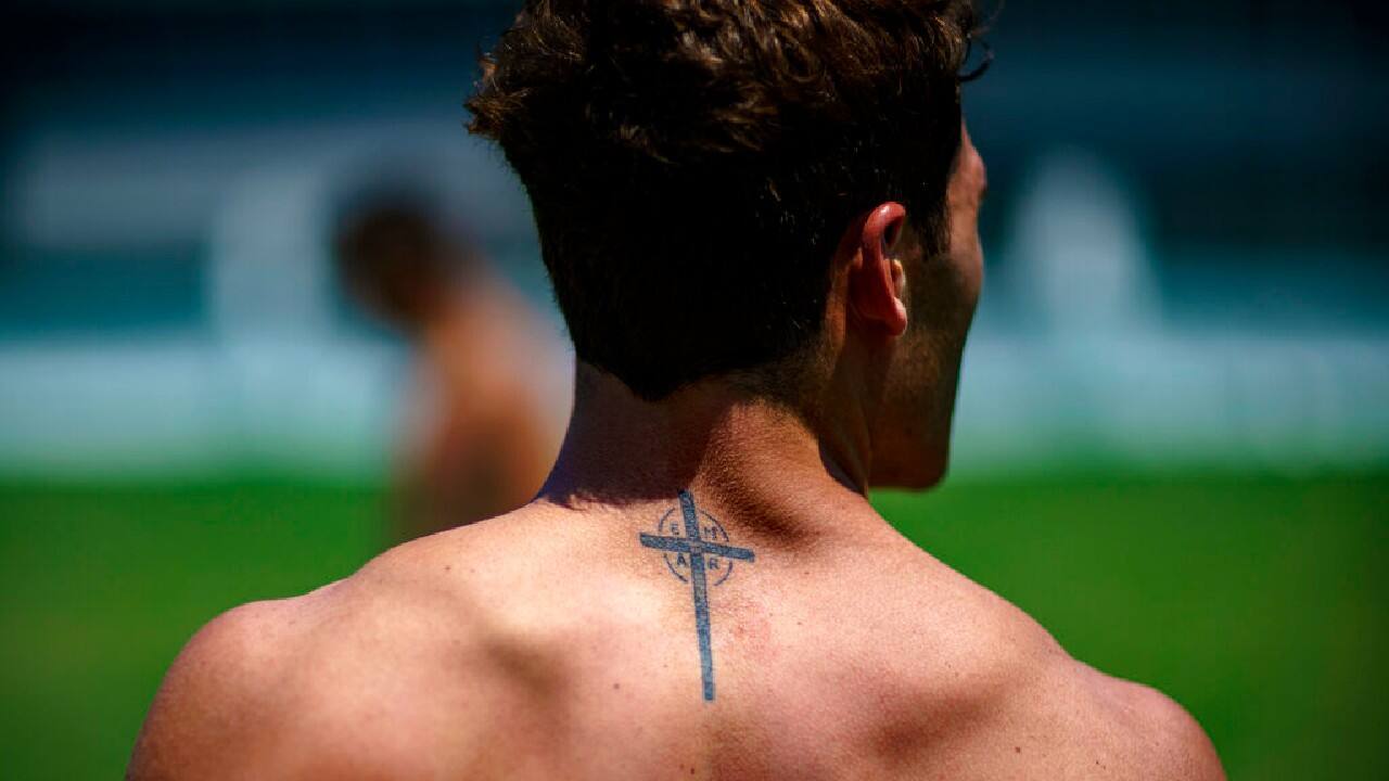 A tattoo decorates the back of Argentina's Rodrigo Isgro as he walks off the field after a men's rugby sevens practice at the Tokyo 2020 Olympics, in Tokyo, July 23.