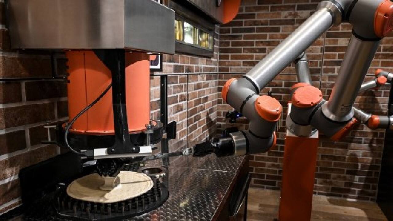 "It's a very fast process, the timing is perfectly controlled and quality is assured because the robots are consistent," says Sebastien Roverso, 34, a co-founder and inventor of the Pazzi robot and its namesake restaurant. "And it's a pretty cool and relaxed atmosphere," he says. "The idea is that you spend a few pleasant minutes watching the robot while waiting." Or as the sign says in English out front: "Come for the show, Stay for the Pizza!" (Image: AFP)