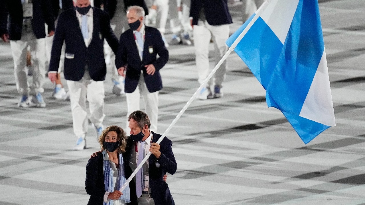 Cecilia Carranza Saroli and Santiago Raul Lange, of Argentina, carry their country's flag during the opening ceremony in the Olympic Stadium at the 2020 Summer Olympics, July 23, in Tokyo, Japan. (Image: AP)