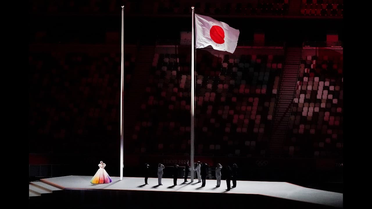 Officials raise the flag of Japan during the opening ceremony in the Olympic Stadium at the 2020 Summer Olympics, Friday, July 23, 2021, in Tokyo, Japan. 