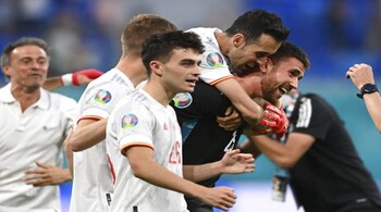 Spain's goalkeeper Unai Simon celebrates with teammates after saving a penalty during the Euro 2020 soccer championship quarterfinal match between Switzerland and Spain, at the Saint Petersburg stadium in Saint Petersburg, Friday, July 2, 2021. (Kirill Kudryavtsev, Pool via AP)